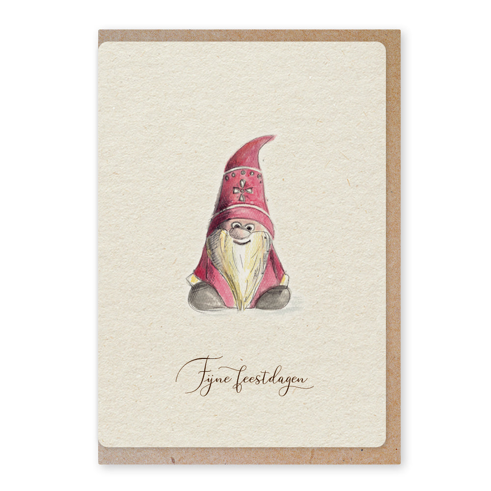 Een mooie duurzame enkele kaart met een tafereel van een tomte / kerstkabouter in aquarel voor een Kerstgroet of een Nieuwjaarswens. De illustraties zijn gemaakt in onze grafische studio. Gedrukt op Paperwise Naturel, boomvrij papier van landbouwrestafval.&nbsp;